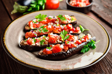 Baked eggplants with tomatoes, onion and garlic