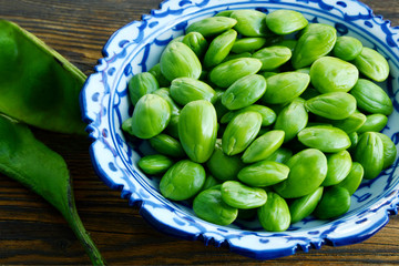 Parkia speciosa or English name is bitter bean, twisted cluster bean or stink bean and Thai name is sataw or sator  on wooden background.