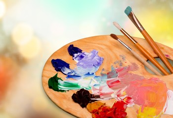Wooden art palette with blobs of paint