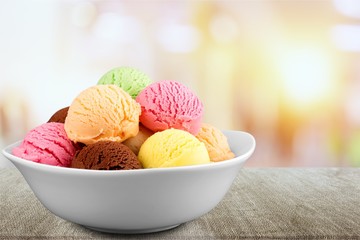 Ice cream scoops in bowl on white