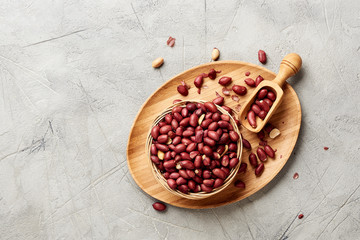 Bowl of fried peanut and scoop. Top view..