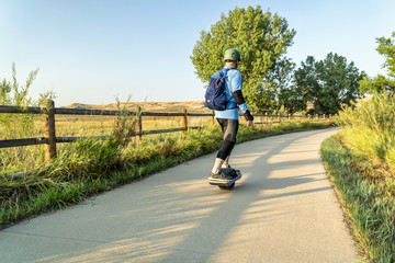 riding electric skateboard on bike trail © MarekPhotoDesign.com