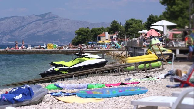 Mediterranean beach with a jet ski in Croatia - July 2018: Adriatic sea, Brac Island