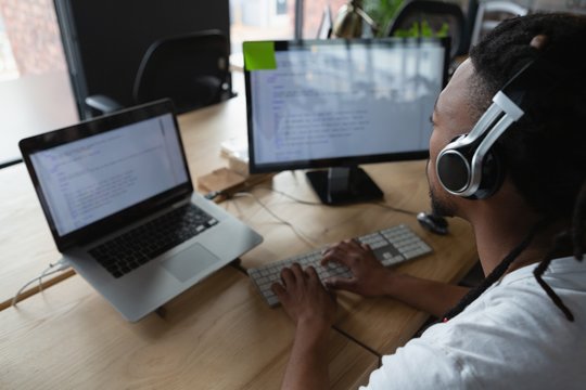 Male executive with headset working at desk