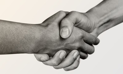 Business agreement handshake on white background. Black