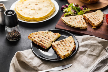 Mexican quesadilla with chicken, tomato, corn, onion, cheese