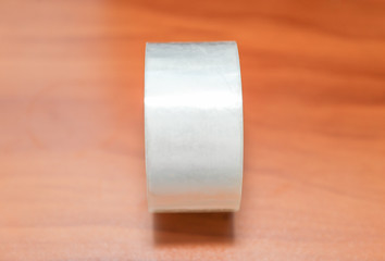 Roll of masking tape on wooden background