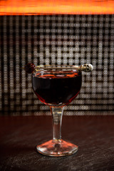 Cocktail in a wine glass with a cherry on a skewer