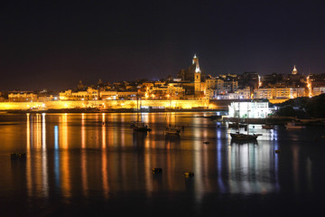 Fototapeta na wymiar Night lights of Valletta Grand Harbour from Sliema, Malta