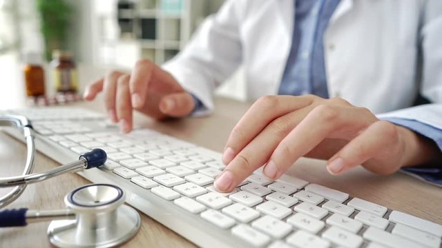 Female doctor typing on computer