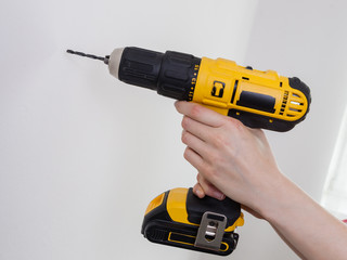 Hand holding yellow drill