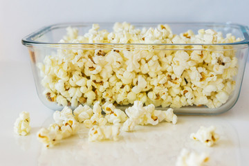 Close-up of a delicious popcorn texture on a white bacground. Shallow dept of field. Concept food by nature.