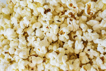 Close-up of a delicious popcorn texture on a white bacground. Shallow dept of field. Concept food by nature.