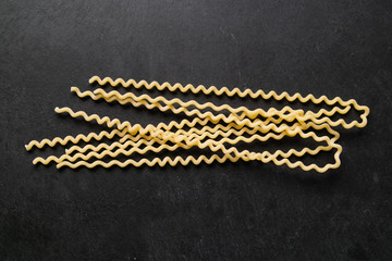 A pack of fusilli on a slate plate