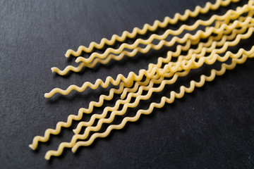 A pack of fusilli on a slate plate