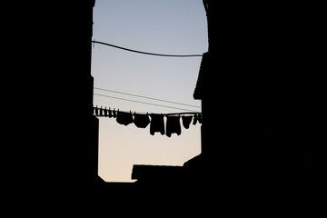 Clothes drying outdoor with historic architecture around. Back light. Picturesque scene in Split, Croatia. 