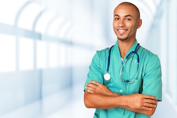 Handsome doctor with stethoscope smiling at camera