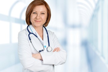 Young woman doctor with stethoscope writting