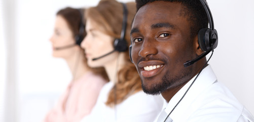 African american call operator in headset. Call center business or customer service concept