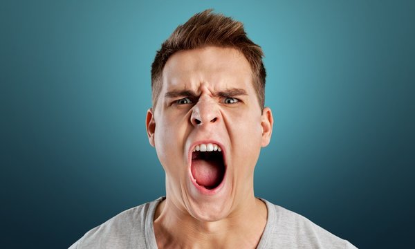 Angry man screaming isolated on background
