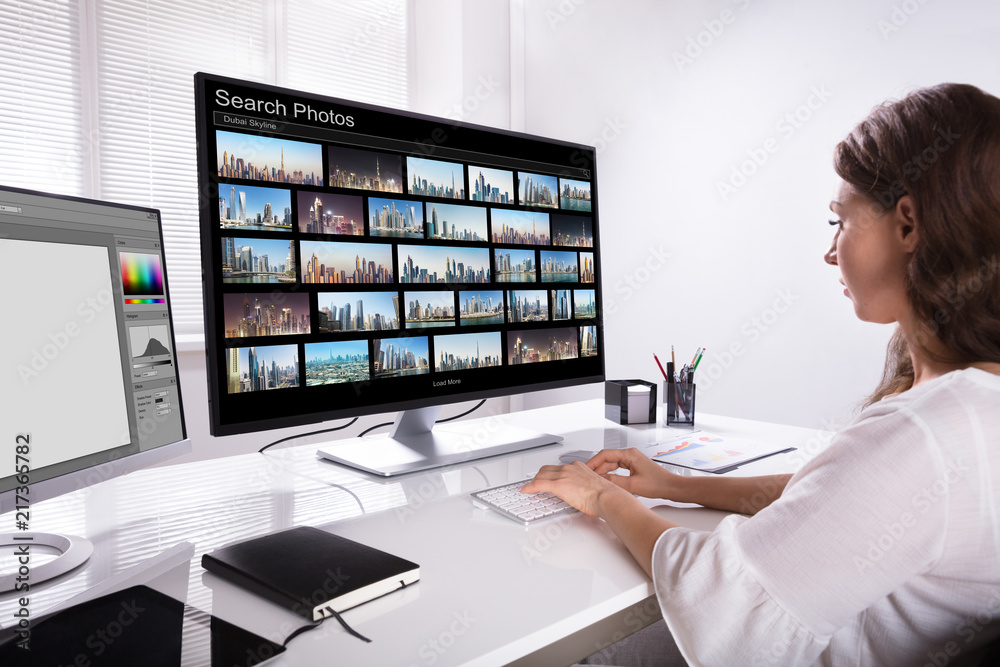 Poster editor searching photos on computer