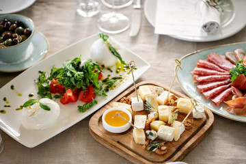 Fototapeta na wymiar Italian Caprese salad and Cheese plate.. burrata cheese, tomatoes and basil herb leaves. Balsamic vinegar arranged on white plate
