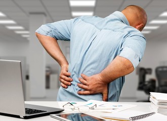 Business man with back pain an office