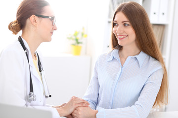 Doctor and  patient  sitting at the desk near window