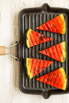 Slices Of Grilled Watermelon In Grilling Pan On A White Wooden Table, Overhead View. Healthy Summer Fruit. Top View, From Above.