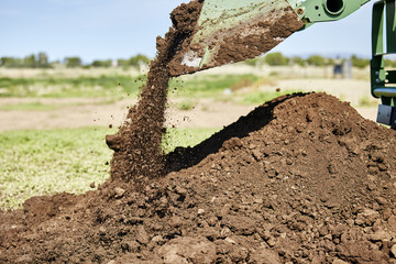 Tractor Bucket dumping Dirt