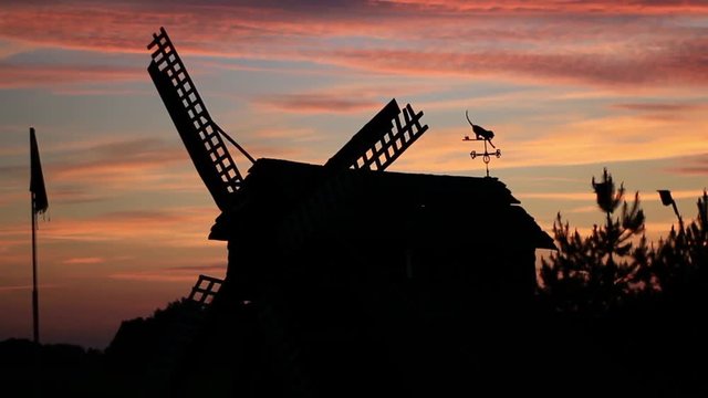 Timelapse of Sunset sky and silhouette of a wooden mill