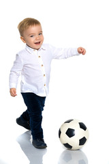 Little boy is playing with a soccer ball.