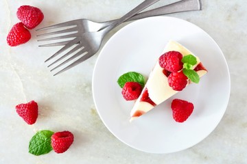 Slice of raspberry cheesecake, top view scene over a bright background