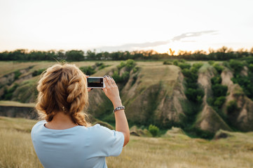 woman tourist taking pictures on the phone nature