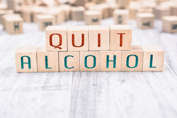 The Words Quit Alcohol Formed By Wooden Blocks On A White Table, Reminder Concept