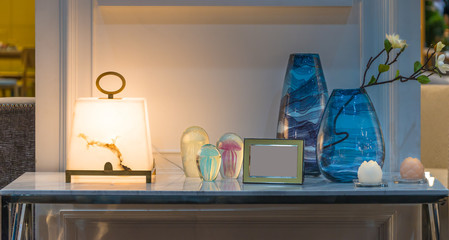 Modern Golden picture frame Table lamp Flower in vase glass bottle on marble table in living room interior decoration