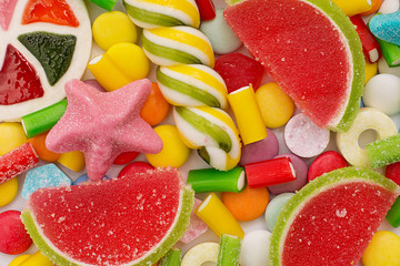 Multicolored candy and lollipops. background
