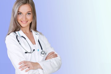 Attractive young female doctor with blurred hospital