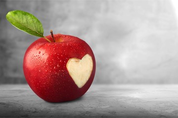 Red apple with a heart shaped cut-out