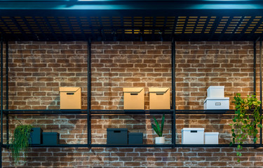 Black metal shelf with paper box on the old brick wall decoration interior