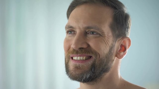 Man checking teeth in front of mirror, dental disease, gum infection, pulpitis