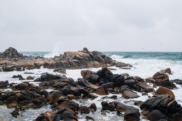 Fototapeta na wymiar Waves crashing on the rocks at Gwangjin beach in Yangyang, Gangwon-do, Korea
