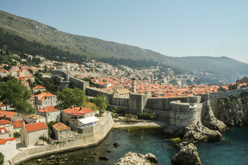 Fototapeta na wymiar Great Walls of the Old town of Dubrovnik, Croatia, seen from above with the Adriatic see in the background. The place is one of the major hotspots for Croatian tourism..