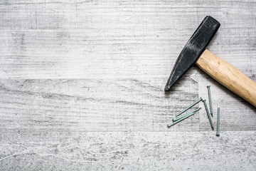 Tool Set Of Hammer And Nails On A Wooden Table - Top Down View With Copy Space