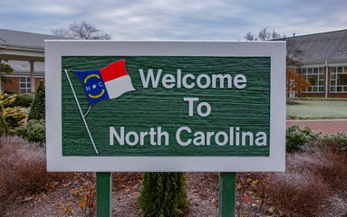 Welcome to North Carolina Sign on Tourist Visitor center background.