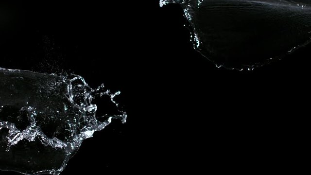 Super slow-motion shot of water splash against black. Shooted with high speed cinema camera at 1000fps