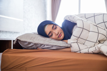 sleeping muslim woman in bed