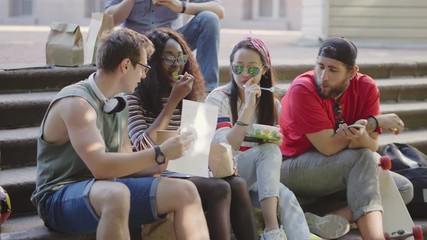 Multicultural group of friends eating
