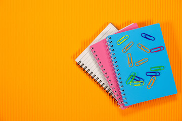 books on orange background.