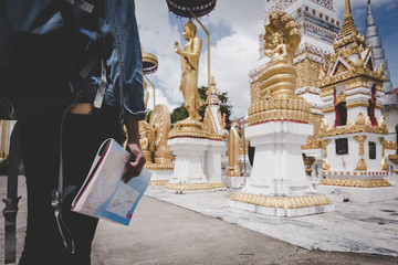 female backpacker is watching Thai temple.